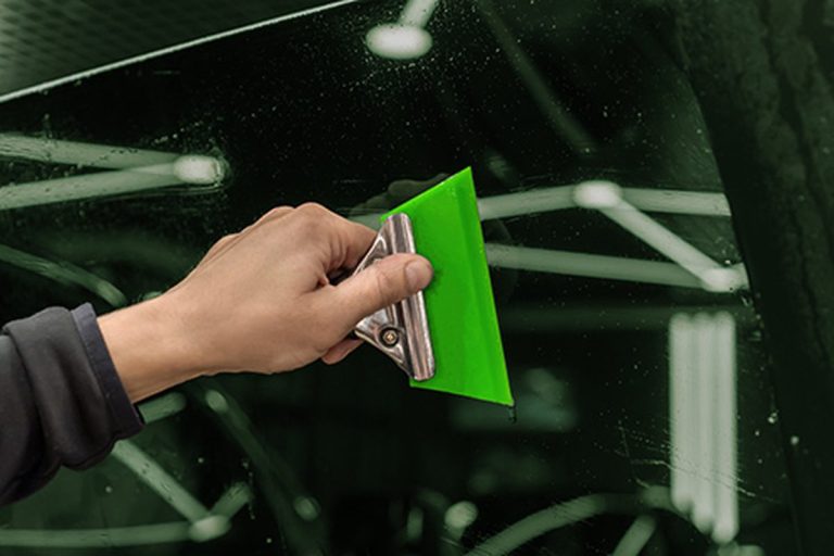 Window film being applied to vehicle glass
