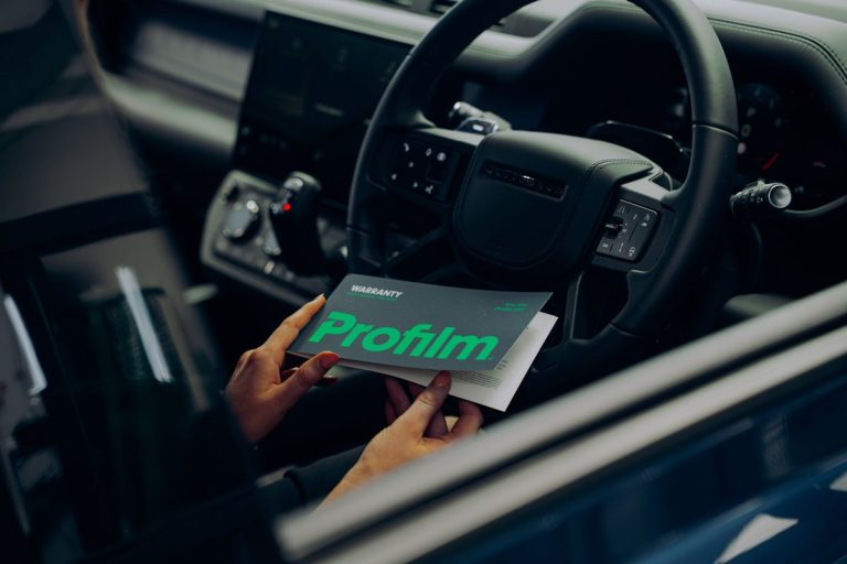 Vehicle owner reviewing protection film documentation on a tablet